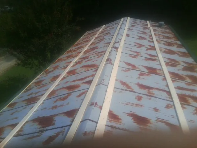 Rusted metal roof panels with new wood purlins before replacement — Storm Damage Roof Repair in Clarington by Roofing Brothers